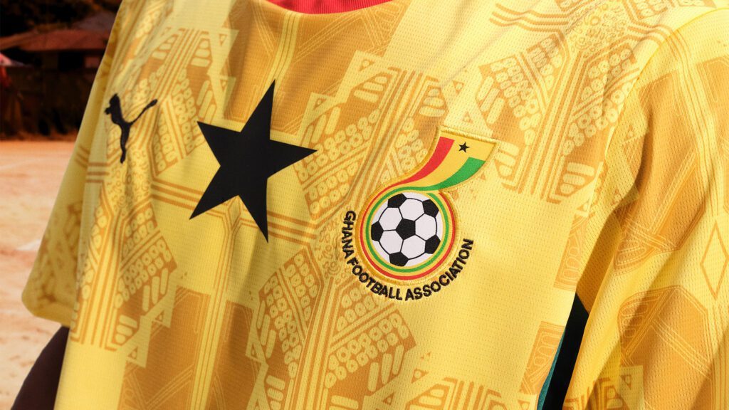 Close-up of a yellow Ghana national team jersey with a black star